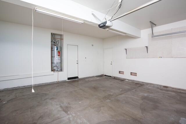 2447 Brompton Ct, Palmdale, CA 93551 - garage with water heater and a garage door opener