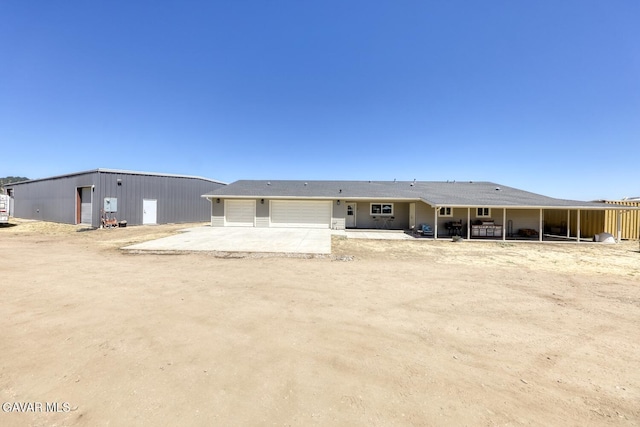 19426 Cavalier Ct, Tehachapi, CA 93561 - rear view of property with a garage and driveway