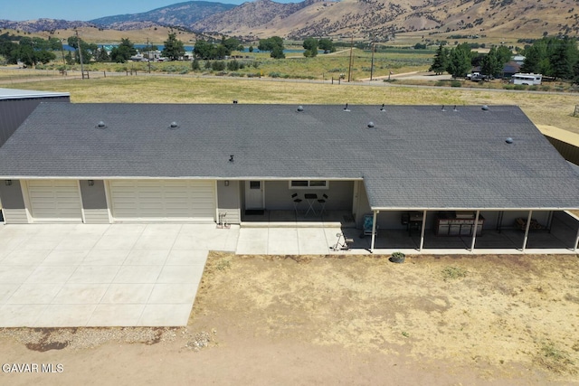 19426 Cavalier Ct, Tehachapi, CA 93561 - view of front of property featuring an attached garage, a mountain view, concrete driveway, and roof with shingles