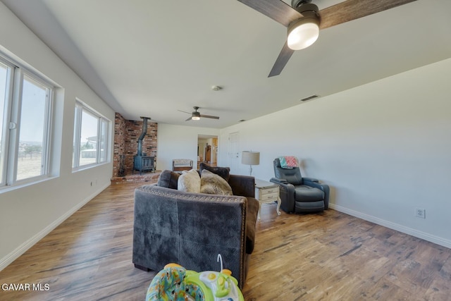 19426 Cavalier Ct, Tehachapi, CA 93561 - living room with a wood stove, ceiling fan, and wood finished floors