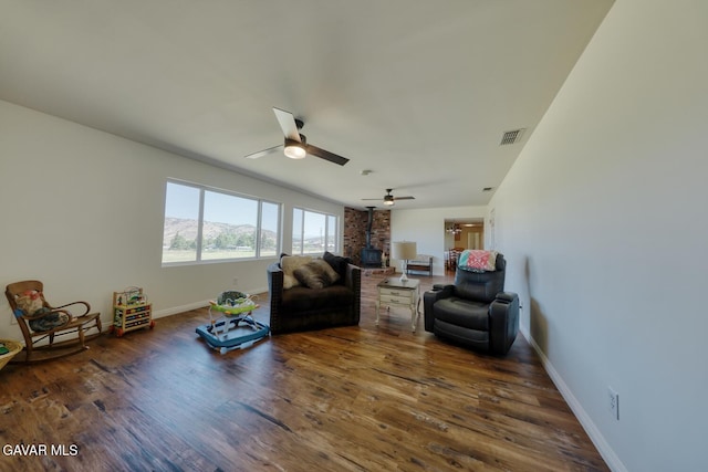 19426 Cavalier Ct, Tehachapi, CA 93561 - living area with a wood stove, a ceiling fan, and wood finished floors