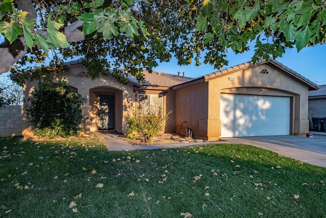 view of front of house with a front yard and a garage