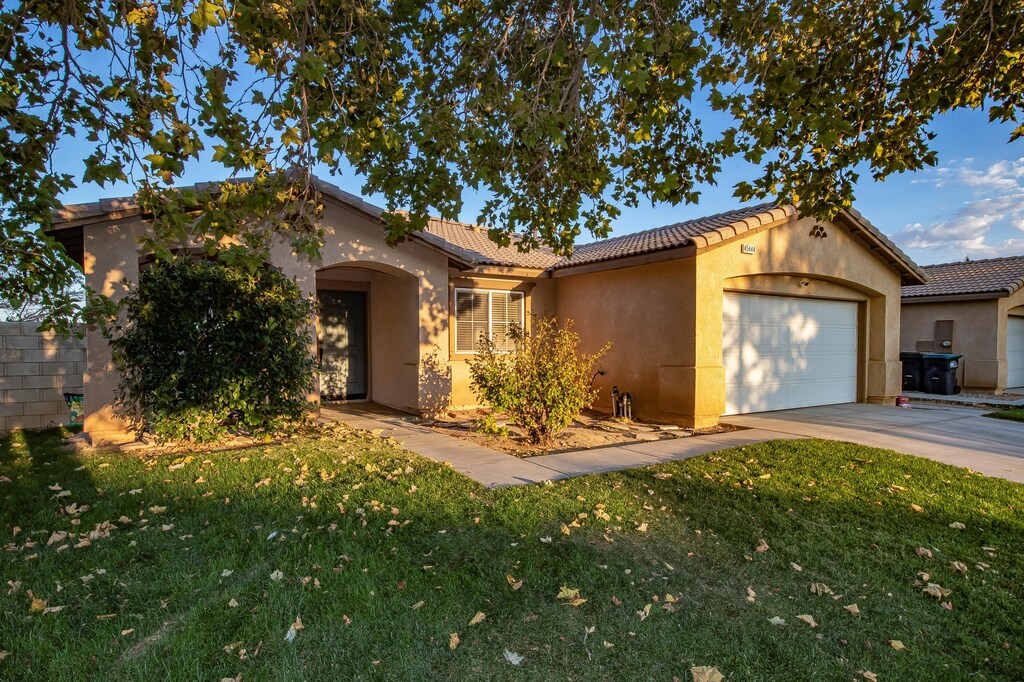 view of front of property with a front lawn and a garage