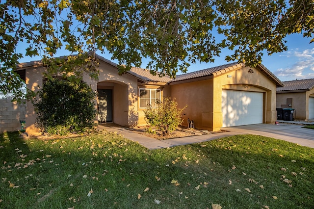 view of front of property with a front lawn and a garage