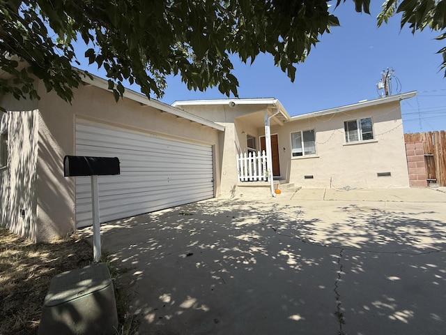 44246 Foxton Ave, Lancaster, CA 93535 - back of house with an attached garage, driveway, and stucco siding