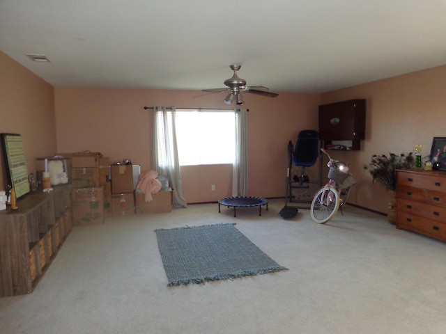 interior space featuring ceiling fan and carpet