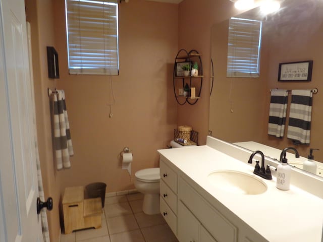 bathroom with tile patterned flooring, vanity, and toilet