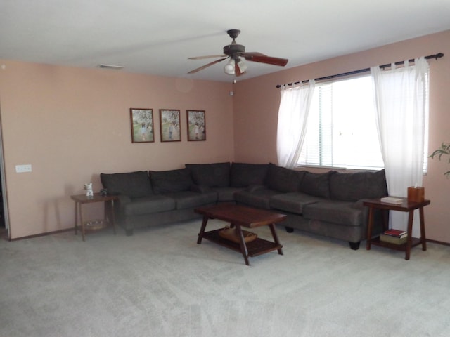 carpeted living room featuring ceiling fan