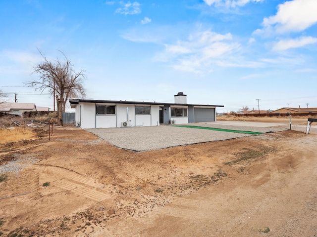 single story home with a chimney and fence