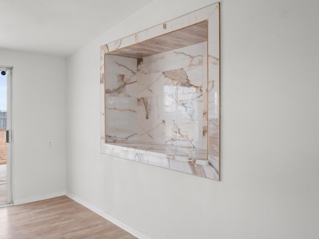 empty room with baseboards and wood finished floors