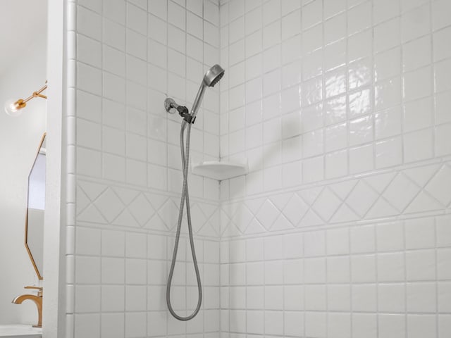 interior details featuring a tile shower