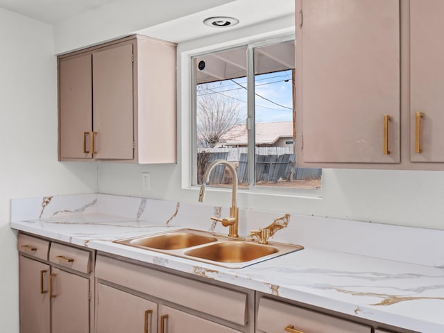 kitchen featuring a sink, dishwasher, and light countertops