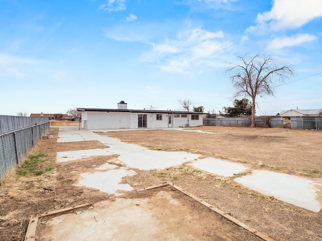 back of property featuring a fenced backyard