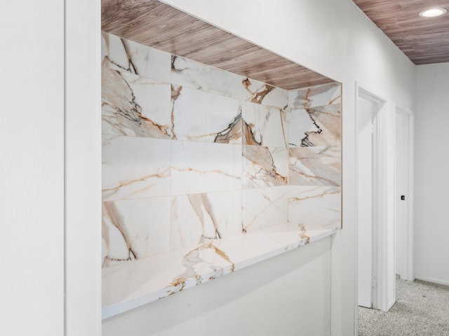 room details featuring carpet and wood ceiling