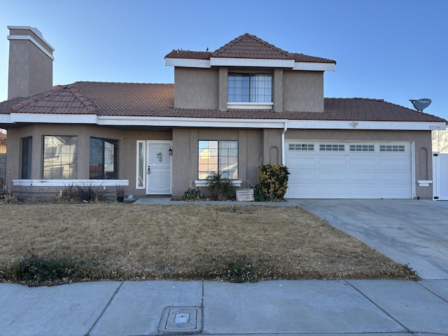 front facade with a front yard and a garage