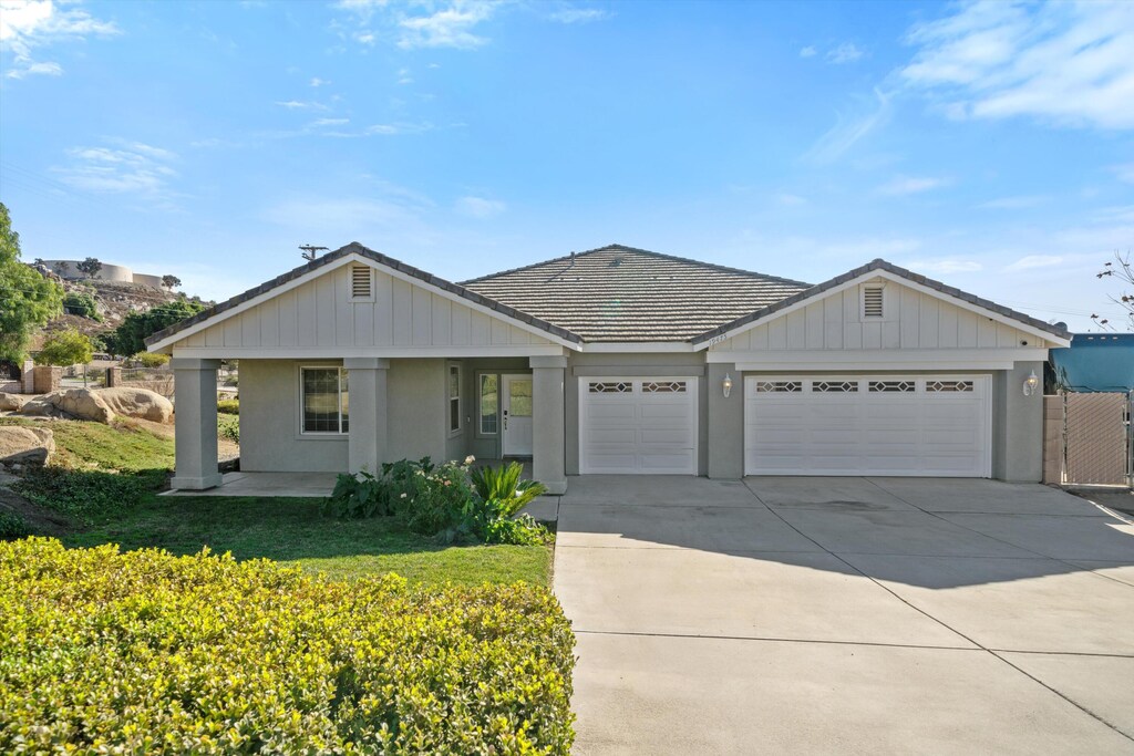 ranch-style home featuring a garage and a front yard