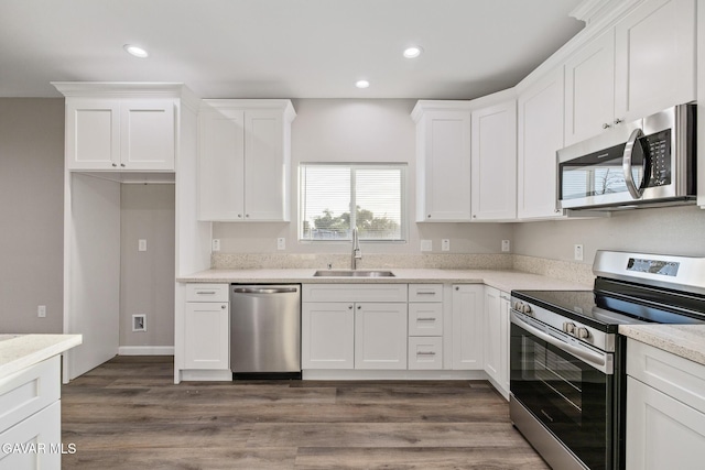 40719 E 171st St, Lake Los Angeles, CA 93535 - kitchen featuring stainless steel appliances, white cabinets, recessed lighting, and dark wood-type flooring