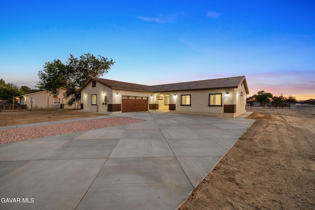 40719 E 171st St, Lake Los Angeles, CA 93535 - single story home with concrete driveway, a garage, stucco siding, and a tile roof
