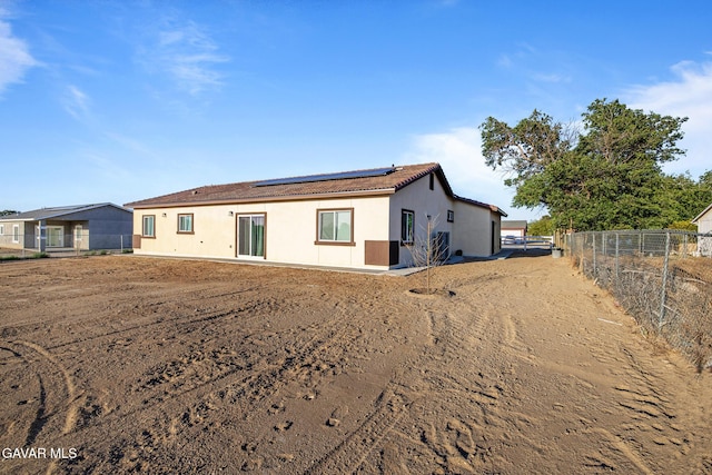 40719 E 171st St, Lake Los Angeles, CA 93535 - rear view of house with solar panels, stucco siding, and a tiled roof