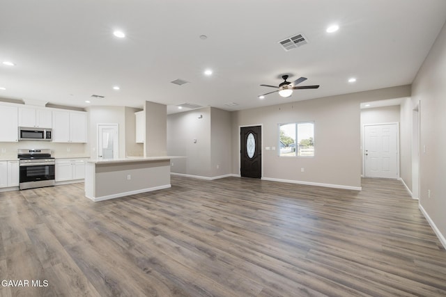 40719 E 171st St, Lake Los Angeles, CA 93535 - unfurnished living room with recessed lighting, a ceiling fan, and wood finished floors