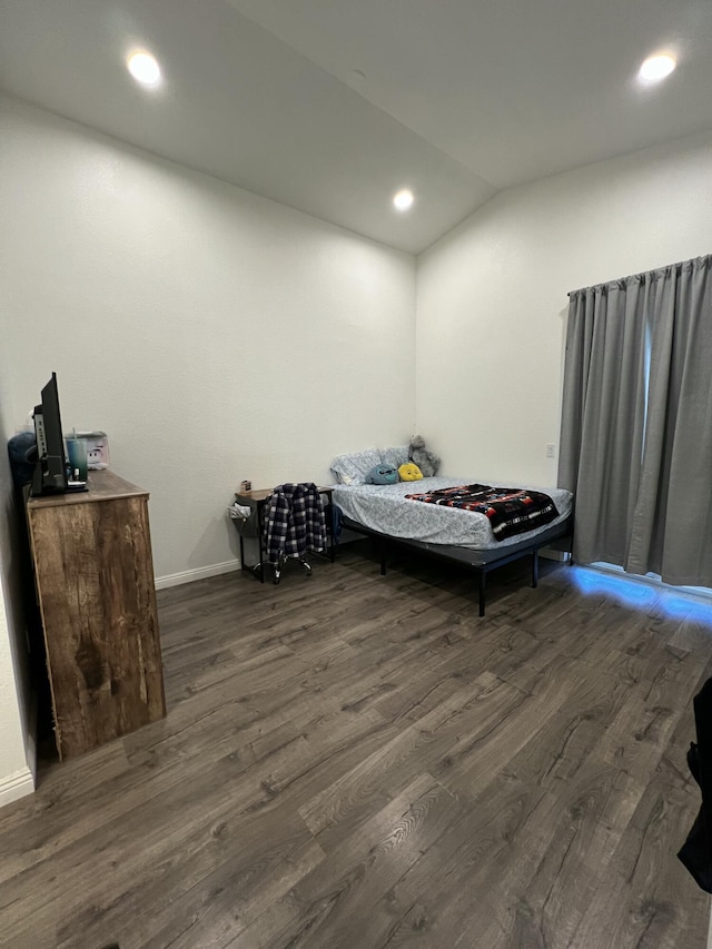 bedroom with dark wood-type flooring and vaulted ceiling