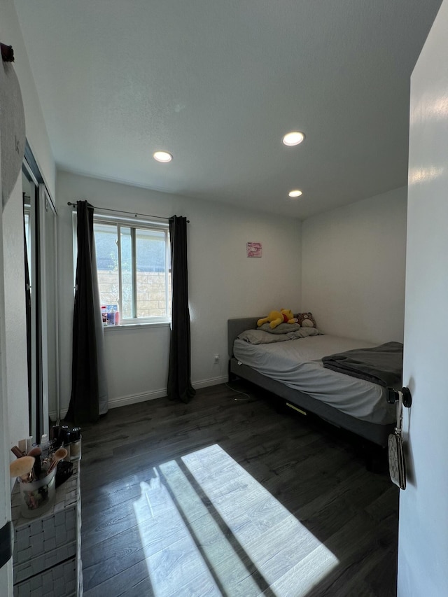 bedroom with dark hardwood / wood-style flooring