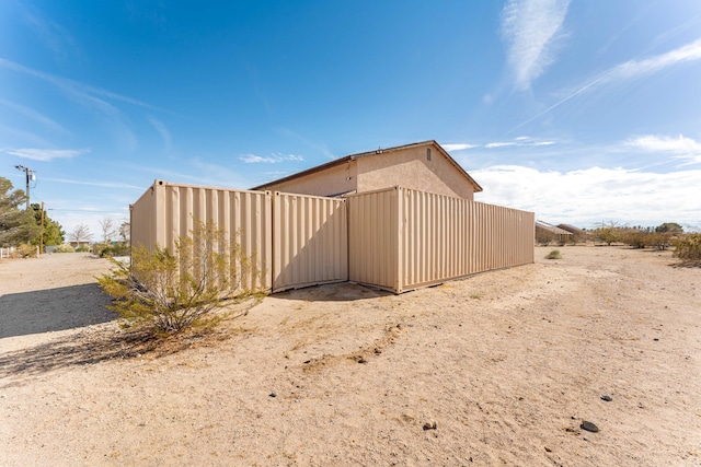 view of side of home with stucco siding