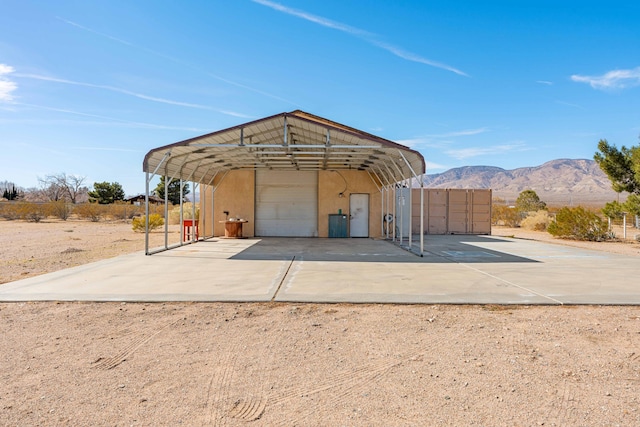 view of outbuilding with a mountain view and dirt driveway