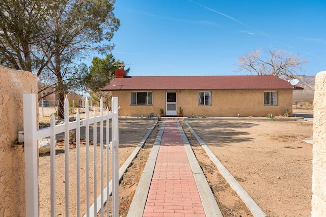 view of front of house featuring a fenced front yard and stucco siding