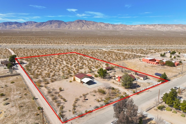 bird's eye view with a mountain view and view of desert