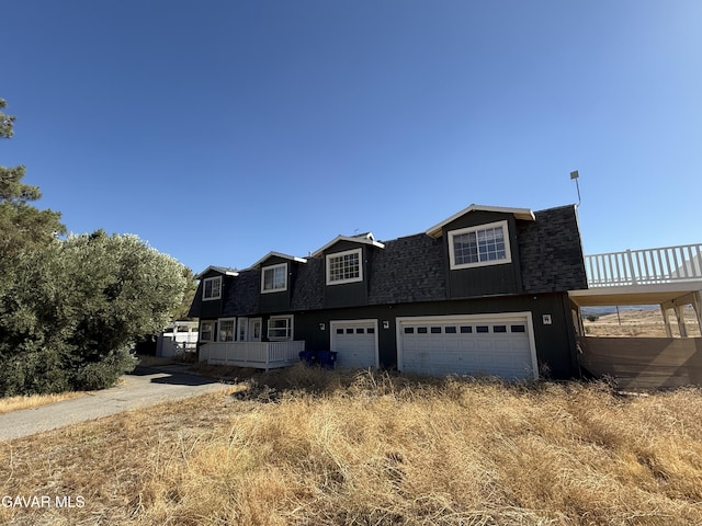 28945 W W Ave C6, Lancaster, CA 93536 - dutch colonial featuring roof with shingles, an attached garage, and driveway