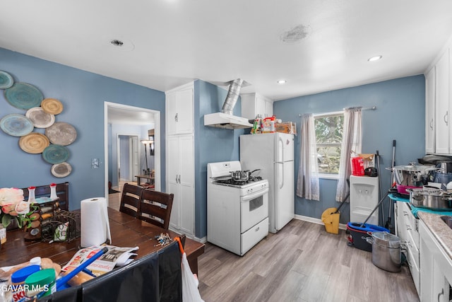 1411 W Ivesbrook St, Lancaster, CA 93534 - kitchen featuring white appliances, wall chimney exhaust hood, light wood-style floors, white cabinetry, and recessed lighting