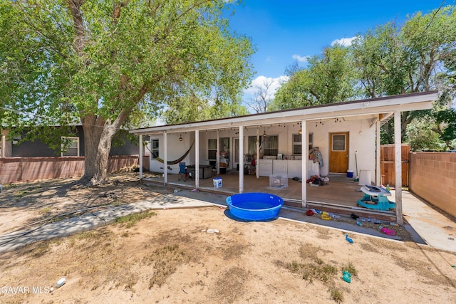 1411 W Ivesbrook St, Lancaster, CA 93534 - back of house featuring a patio, stucco siding, and a wooden deck