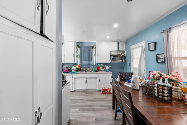 1411 W Ivesbrook St, Lancaster, CA 93534 - kitchen with white cabinetry, recessed lighting, light wood-style flooring, and stainless steel microwave