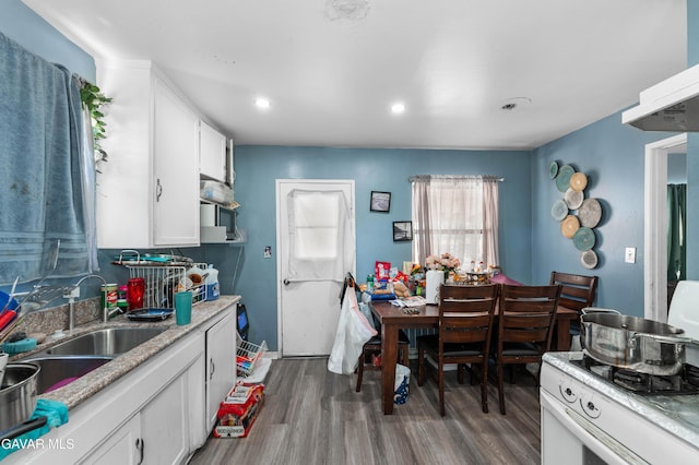 1411 W Ivesbrook St, Lancaster, CA 93534 - kitchen featuring white cabinets, wood finished floors, white range oven, and recessed lighting