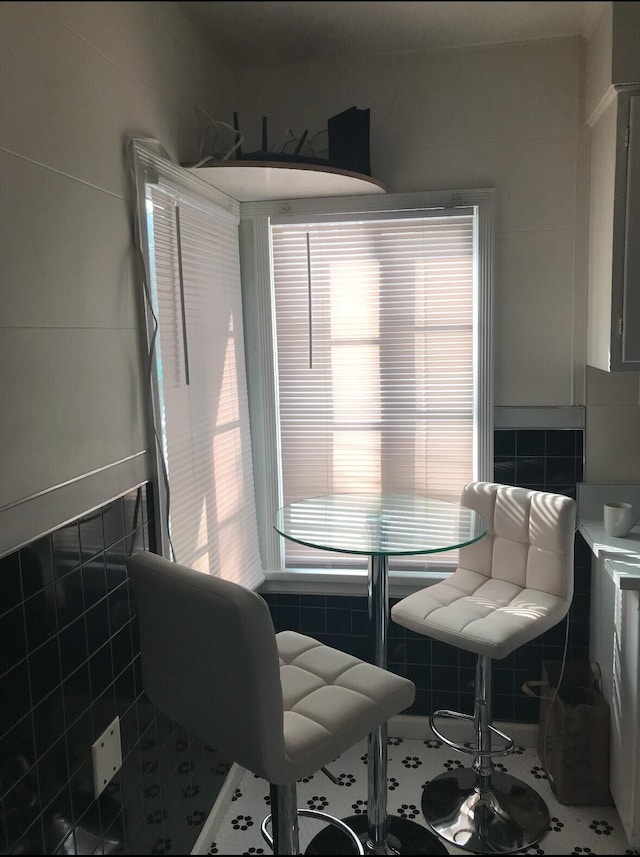 dining area with tile walls