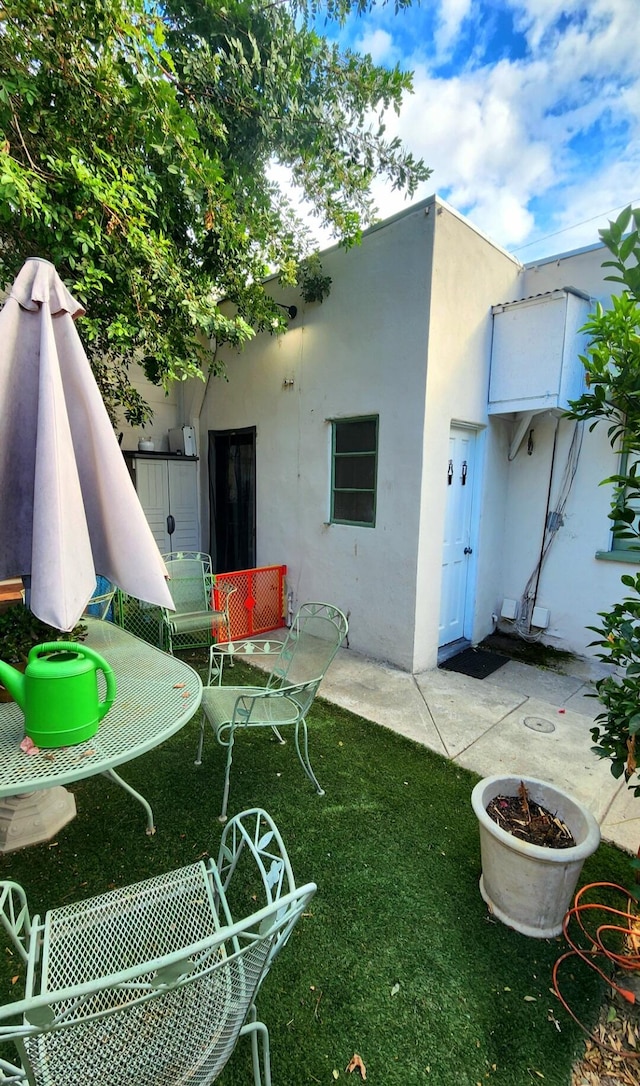 rear view of house featuring a lawn