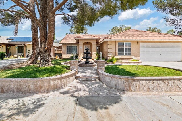 view of front facade with an attached garage, stucco siding, a tile roof, and concrete driveway