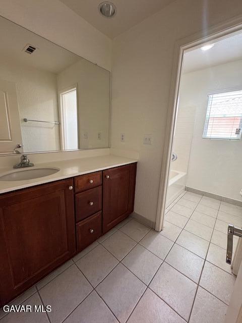 44316 Acacia St, Lancaster, CA 93535 - bathroom with vanity, tile patterned floors, and a bathtub
