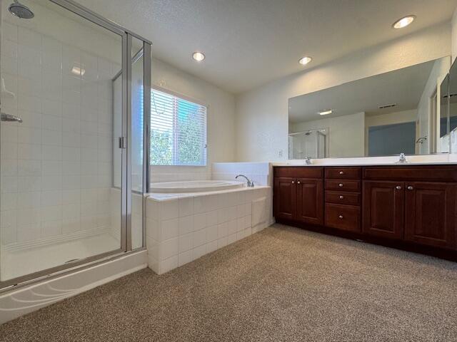 44316 Acacia St, Lancaster, CA 93535 - bathroom featuring a stall shower, double vanity, a garden tub, carpet floors, and recessed lighting
