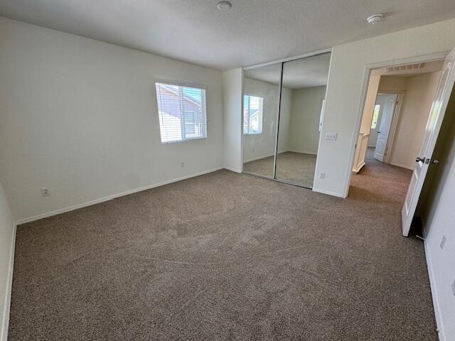 44316 Acacia St, Lancaster, CA 93535 - unfurnished bedroom featuring carpet floors and a closet