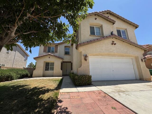 44316 Acacia St, Lancaster, CA 93535 - mediterranean / spanish home featuring stucco siding, a tiled roof, and concrete driveway