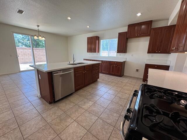 44316 Acacia St, Lancaster, CA 93535 - kitchen featuring dishwasher, black gas range, plenty of natural light, light countertops, and a textured ceiling