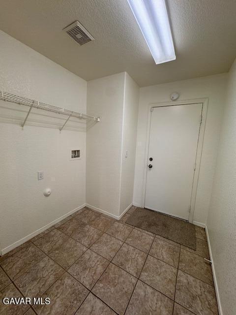 44316 Acacia St, Lancaster, CA 93535 - washroom with washer hookup, a textured ceiling, and tile patterned floors