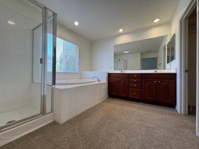 44316 Acacia St, Lancaster, CA 93535 - full bathroom with carpet, double vanity, a shower stall, a garden tub, and recessed lighting