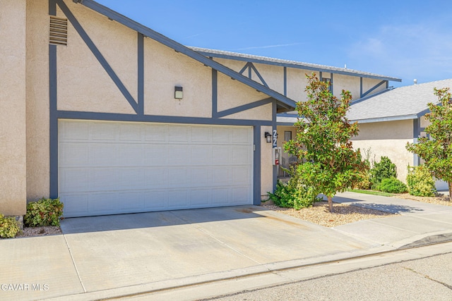 43840 Bobby Jones Dr Apt 22, Lancaster, CA 93536 - townhome / multi-family property with stucco siding, driveway, and a garage