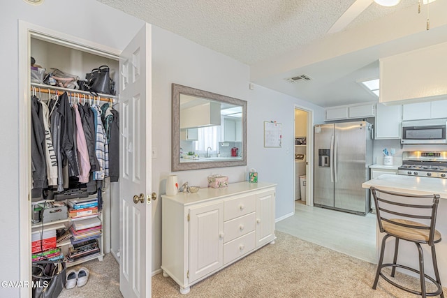 43840 Bobby Jones Dr Apt 22, Lancaster, CA 93536 - kitchen with stainless steel appliances, light colored carpet, light countertops, and a textured ceiling