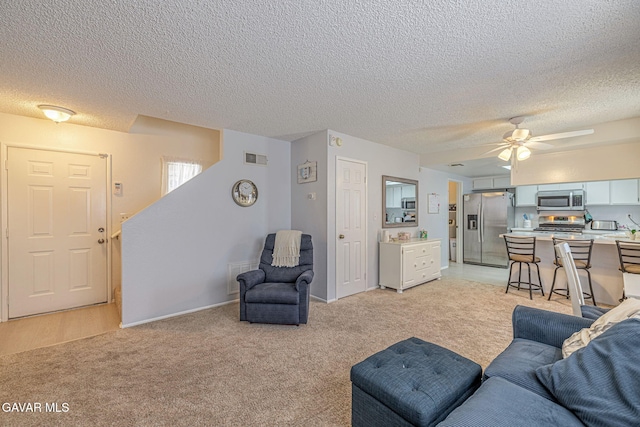 43840 Bobby Jones Dr Apt 22, Lancaster, CA 93536 - living area with light colored carpet, a ceiling fan, and a textured ceiling