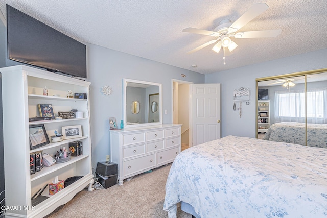 43840 Bobby Jones Dr Apt 22, Lancaster, CA 93536 - bedroom featuring carpet flooring, a textured ceiling, a closet, and a ceiling fan