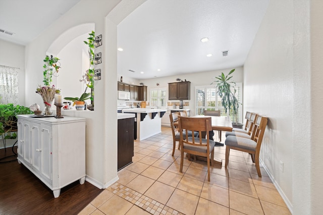 kitchen featuring light tile patterned flooring and dark brown cabinetry